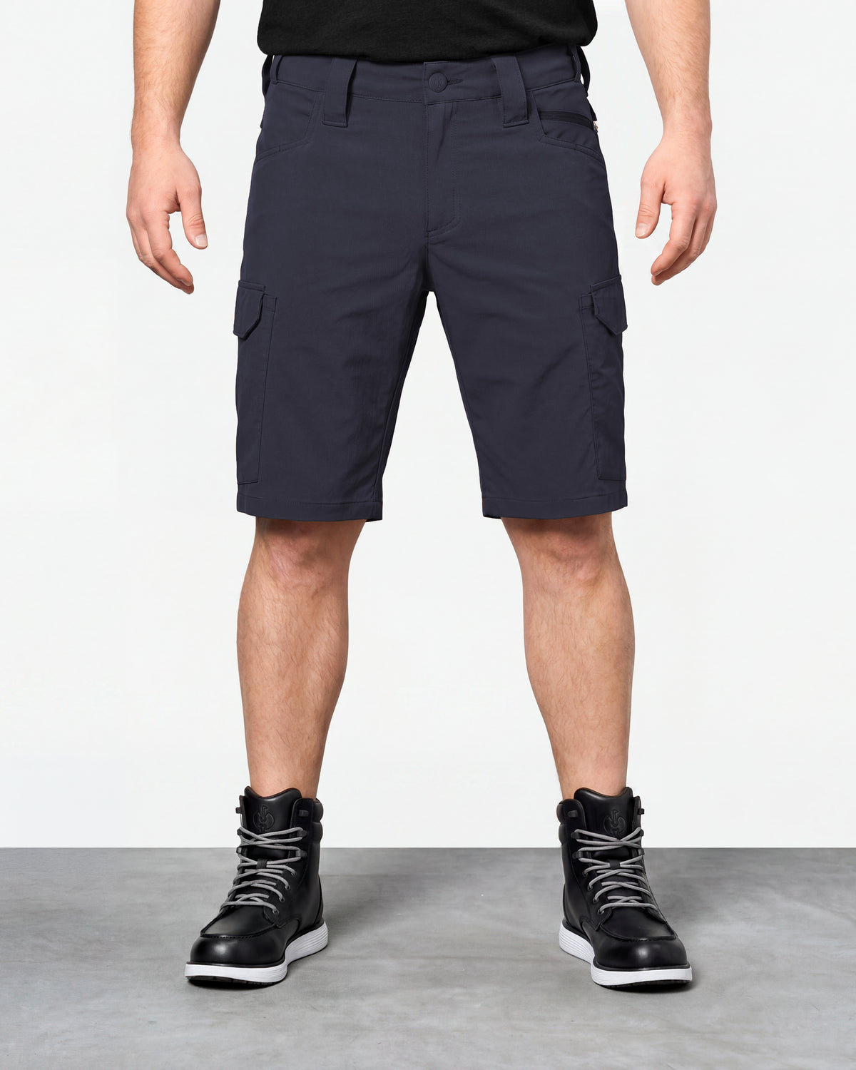 Model wearing Engelbert Strauss e.s. taktik stretch ripstop cargo work shorts in nero blue, showing the fit, length, waistband, and front pocket layout of the durable stretch ripstop cargo work shorts with utility pockets.