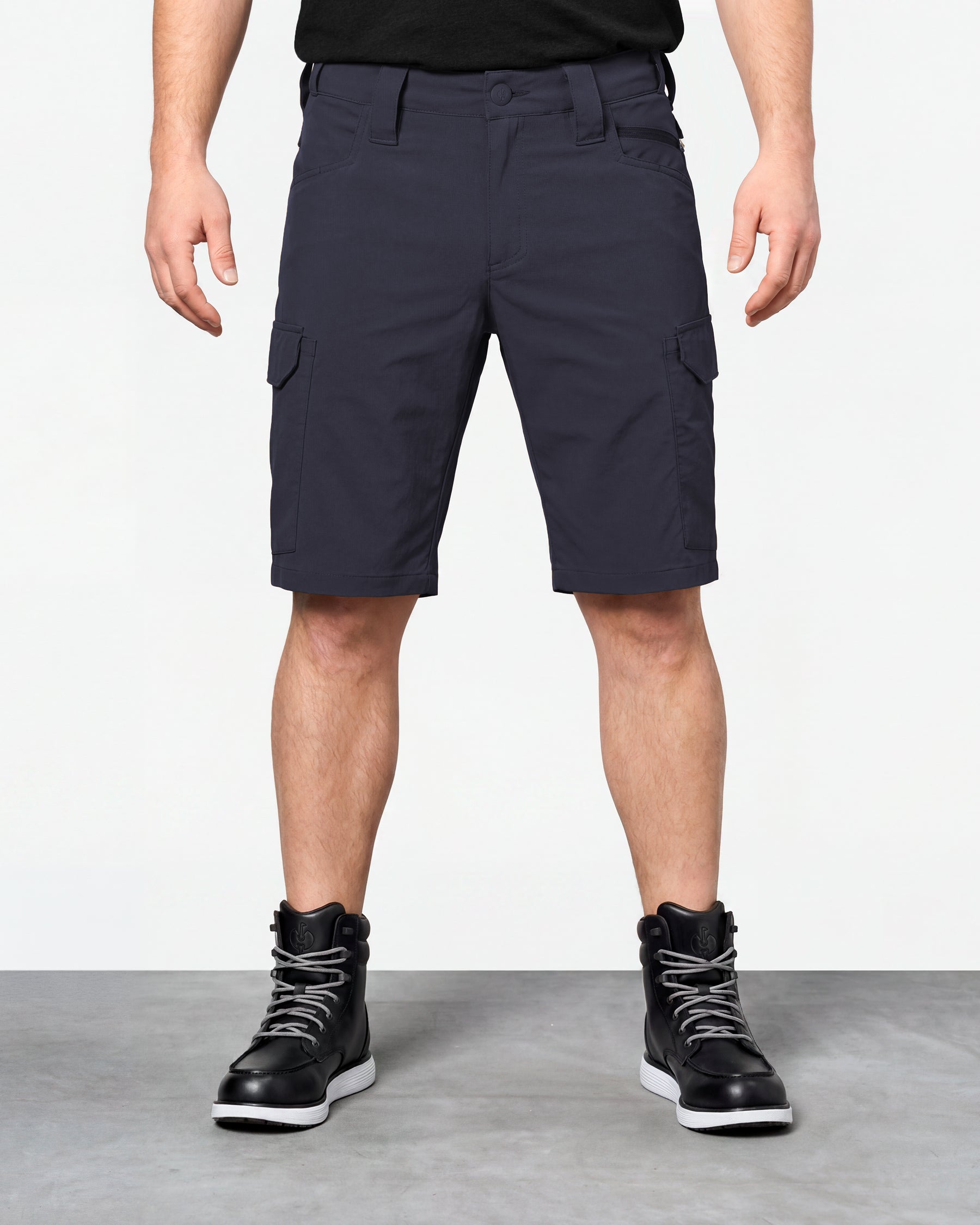 Model wearing Engelbert Strauss e.s. taktik stretch ripstop cargo work shorts in nero blue, showing the fit, length, waistband, and front pocket layout of the durable stretch ripstop cargo work shorts with utility pockets.