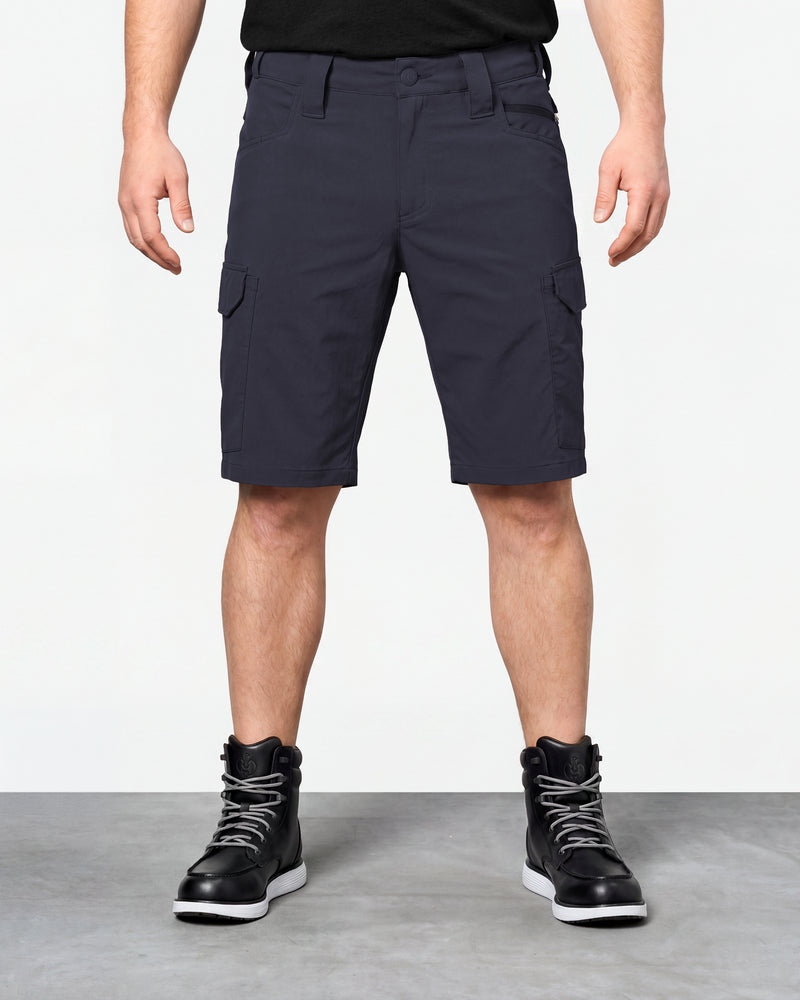 Model wearing Engelbert Strauss e.s. taktik stretch ripstop cargo work shorts in nero blue, showing the fit, length, waistband, and front pocket layout of the durable stretch ripstop cargo work shorts with utility pockets.