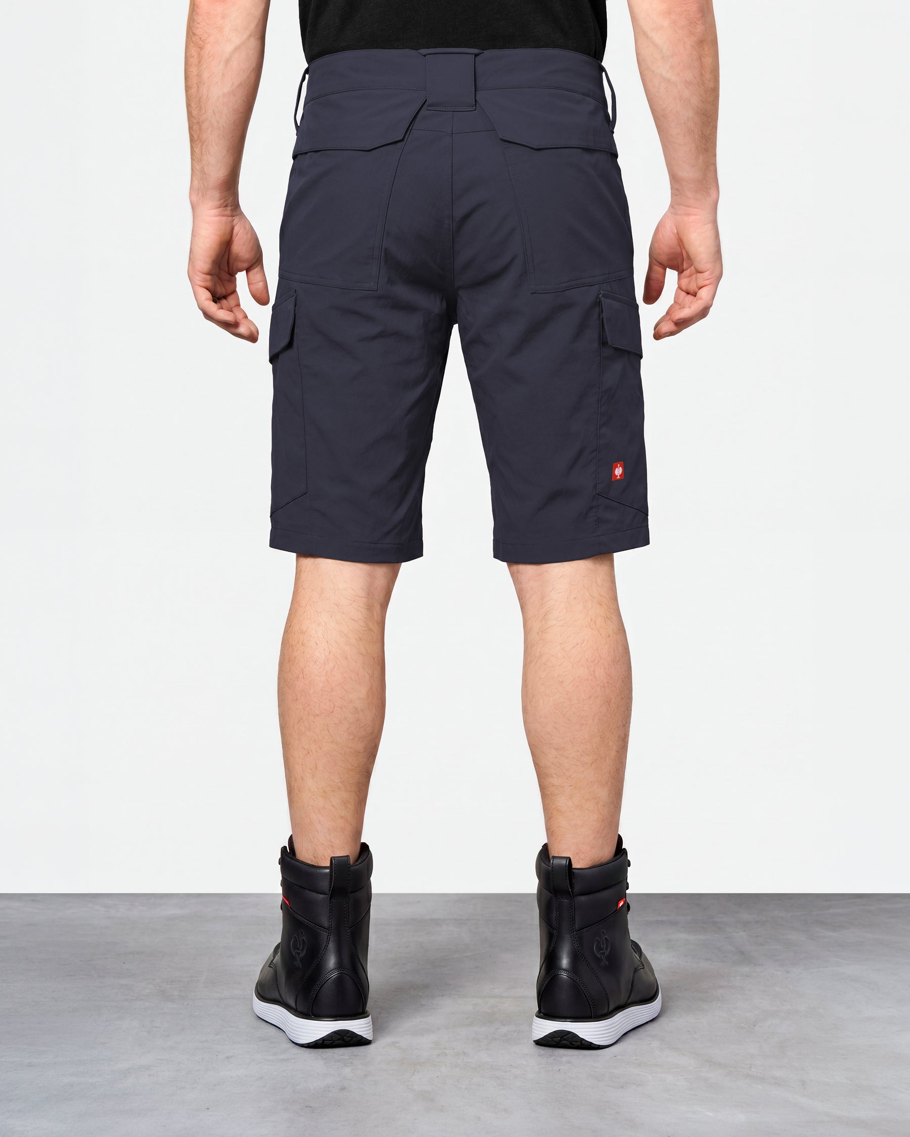 Alternate model view of Engelbert Strauss e.s. taktik stretch ripstop cargo work shorts in nero blue, showing the side and back fit with visible utility pocket placement and workwear construction.