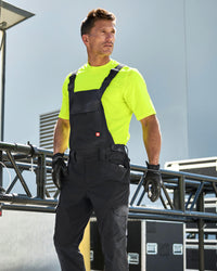 black STRAUSS Stretch Ripstop Cargo Work Bib Overall e.s.taktik shown during active work
