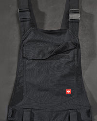 Close-up of black STRAUSS Stretch Ripstop Cargo Work Bib Overall e.s.taktik seam, hardware, and workwear details