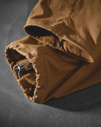 Close-up of desert brown STRAUSS Stretch Ripstop Cargo Work Bib Overall e.s.taktik cargo pocket and ripstop fabric details