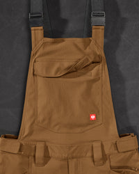 Close-up of desert brown STRAUSS Stretch Ripstop Cargo Work Bib Overall e.s.taktik seam, hardware, and workwear details