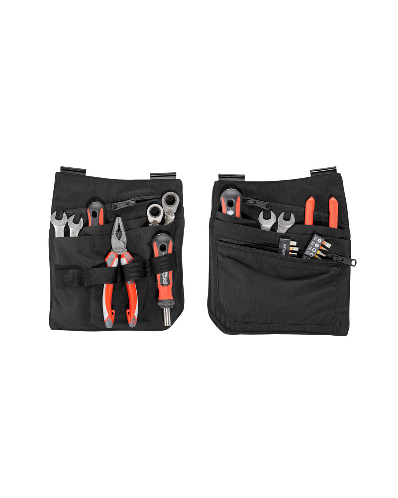 A worker wears a black STRAUSS e.s.concrete light tool bags on a tool belt with utility work pants.