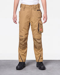 A person wearing tan cargo work pants with black work boots, shown from the waist down against a light gray studio background.