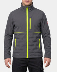 A man wearing a dark gray quilted jacket with bright neon yellow-green zipper accents, shown from the chin down against a light gray studio background.