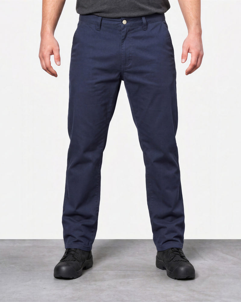 Front view of a model wearing navy STRAUSS canvas work pants with black work shoes.