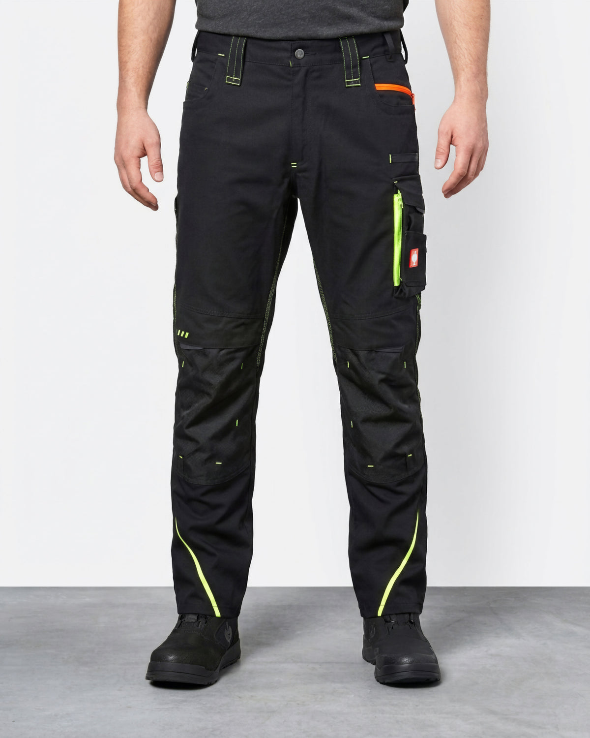 Cargo Work Pants e.s.motion 2020 in black/high-vis yellow-orange worn by a model, front view