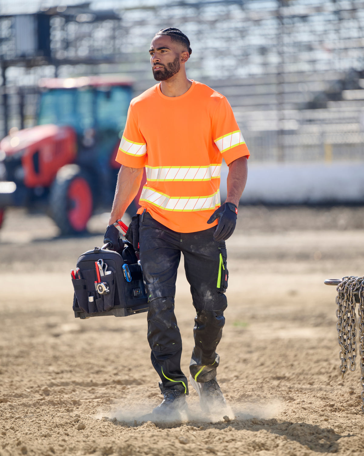 Cargo Work Pants e.s.motion 2020 in black/high-vis yellow-orange shown in an outdoor workwear setting