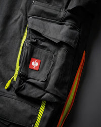 Close-up of cargo pocket details on Cargo Work Pants e.s.motion 2020 in black/high-vis yellow-orange