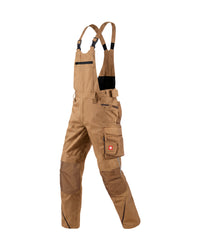 A pair of tan work bib overalls with adjustable suspenders, multiple utility pockets, and reinforced knee patches, shown against a plain white background.