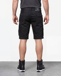 Alternate model view of Engelbert Strauss e.s. motion ten shorts in oxid black, showing the side and back fit with visible utility pocket placement and workwear construction.