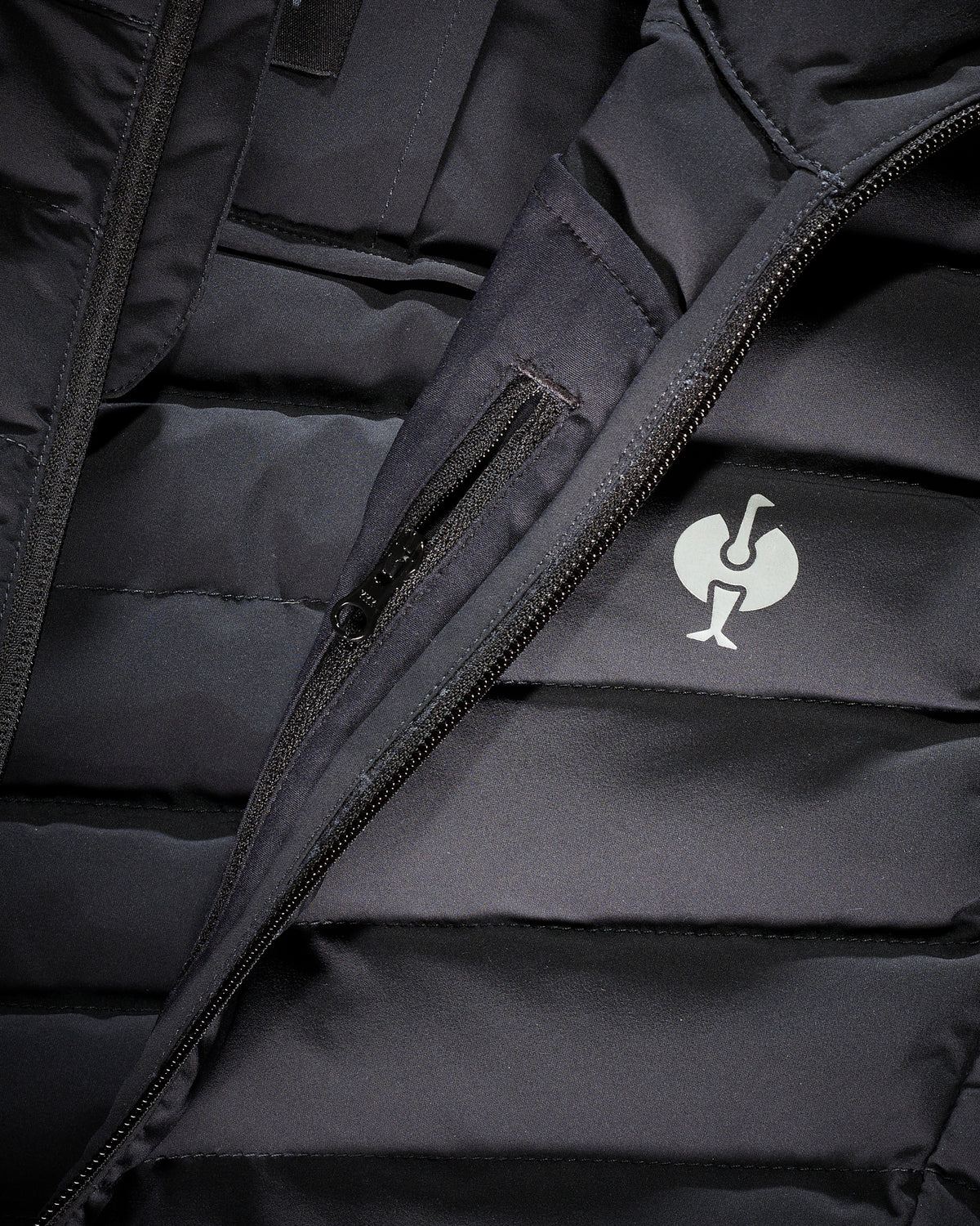 Close-up of quilted vest panels and zipper details on STRAUSS e.s.motion ten vest in oxid black