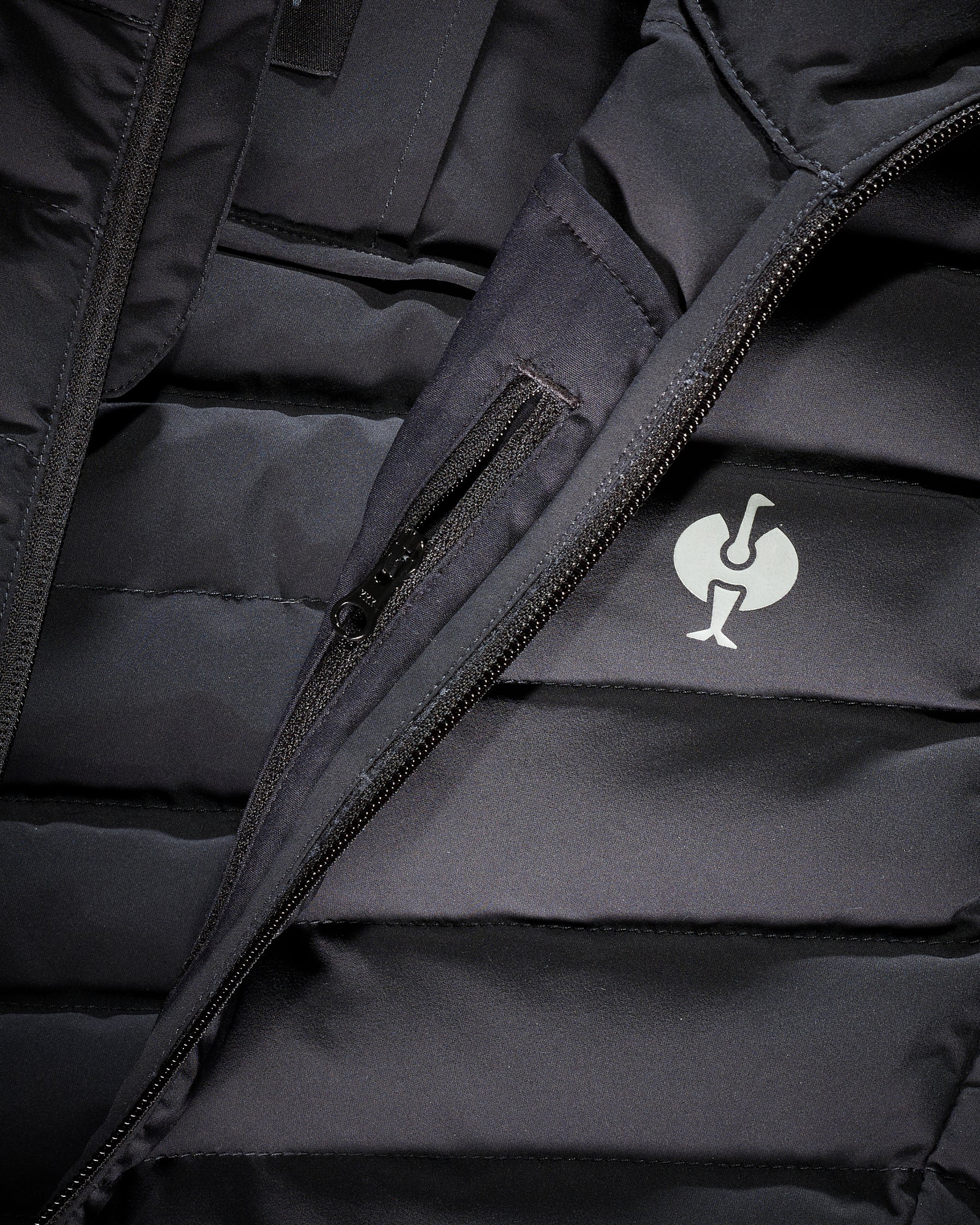 Close-up of quilted vest panels and zipper details on STRAUSS e.s.motion ten vest in oxid black