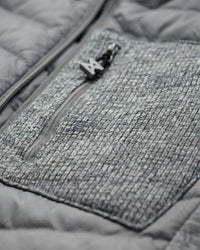 Close-up of quilted and stretch panel details on STRAUSS e.s.motion ten hybrid hooded jacket in gray melange