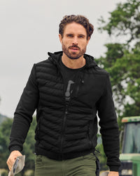 STRAUSS e.s.motion ten hybrid hooded jacket in black worn in a work setting