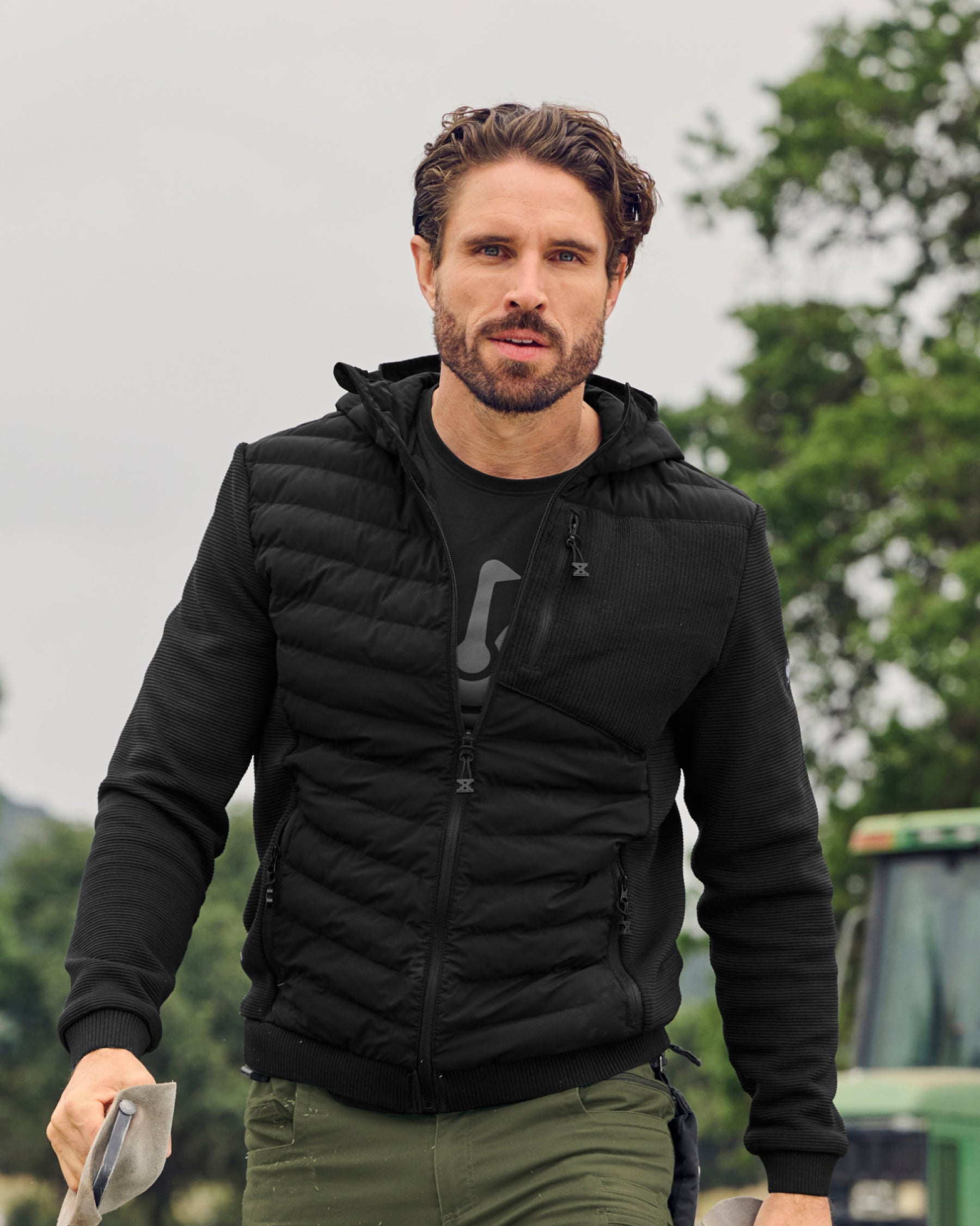 STRAUSS e.s.motion ten hybrid hooded jacket in black worn in a work setting