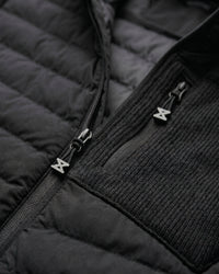 Close-up of quilted and stretch panel details on STRAUSS e.s.motion ten hybrid hooded jacket in black