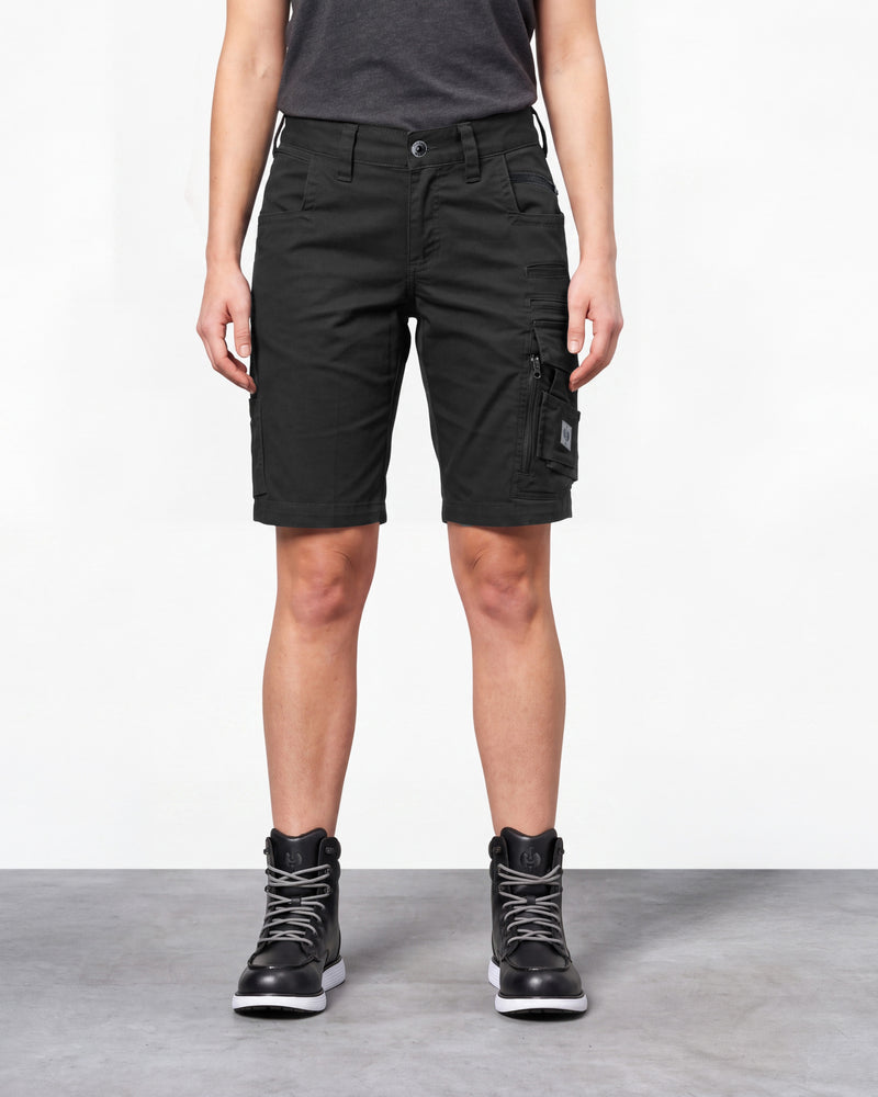 Model wearing Engelbert Strauss women's e.s. motion ten shorts in oxid black, showing the fit, length, waistband, and front pocket layout of the flexible women’s work shorts designed for active movement.