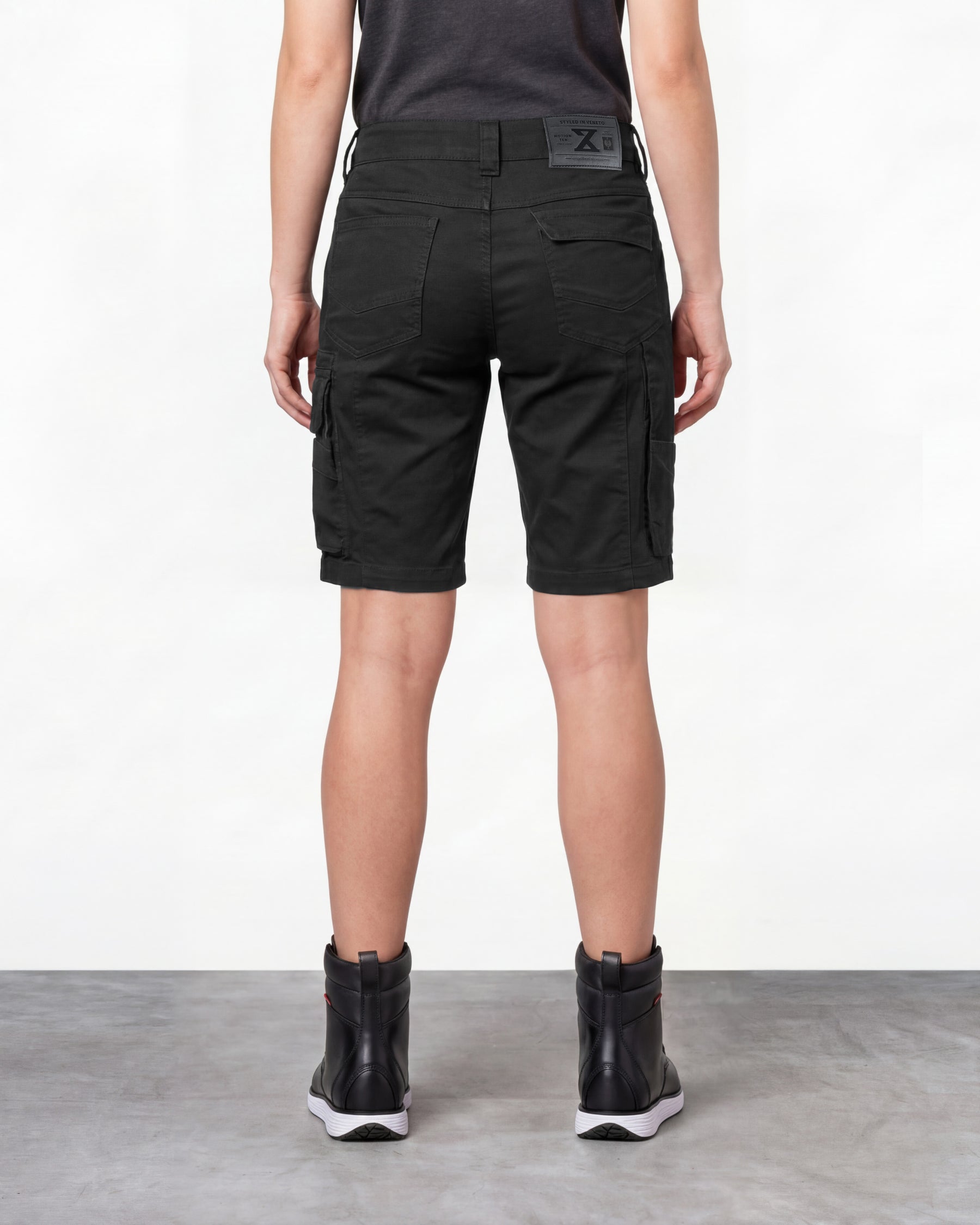Alternate model view of Engelbert Strauss women's e.s. motion ten shorts in oxid black, showing the side and back fit with visible utility pocket placement and workwear construction.