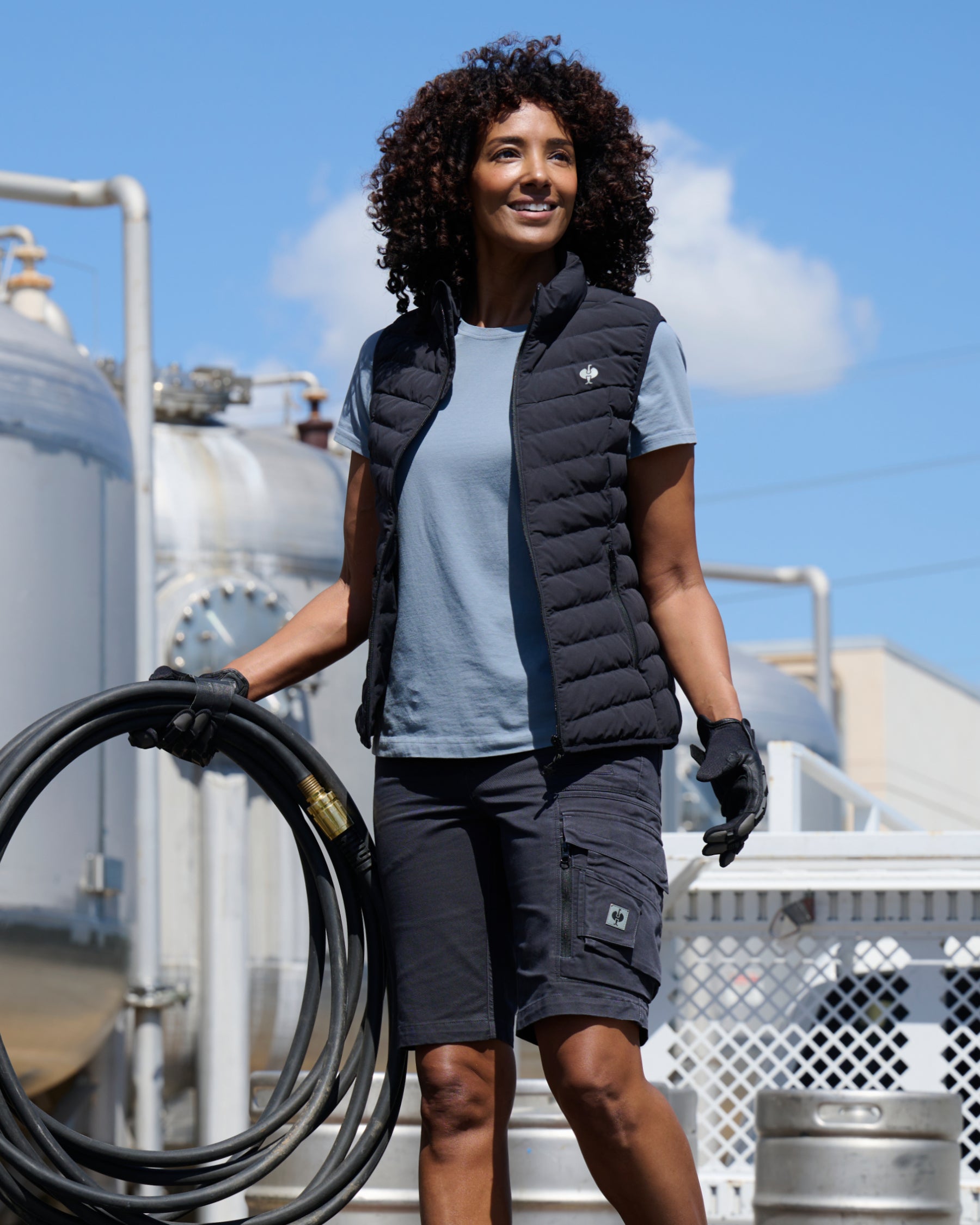 Engelbert Strauss women's e.s. motion ten shorts in oxid black in a lifestyle action view, highlighting the practical pocket access and durable workwear silhouette.