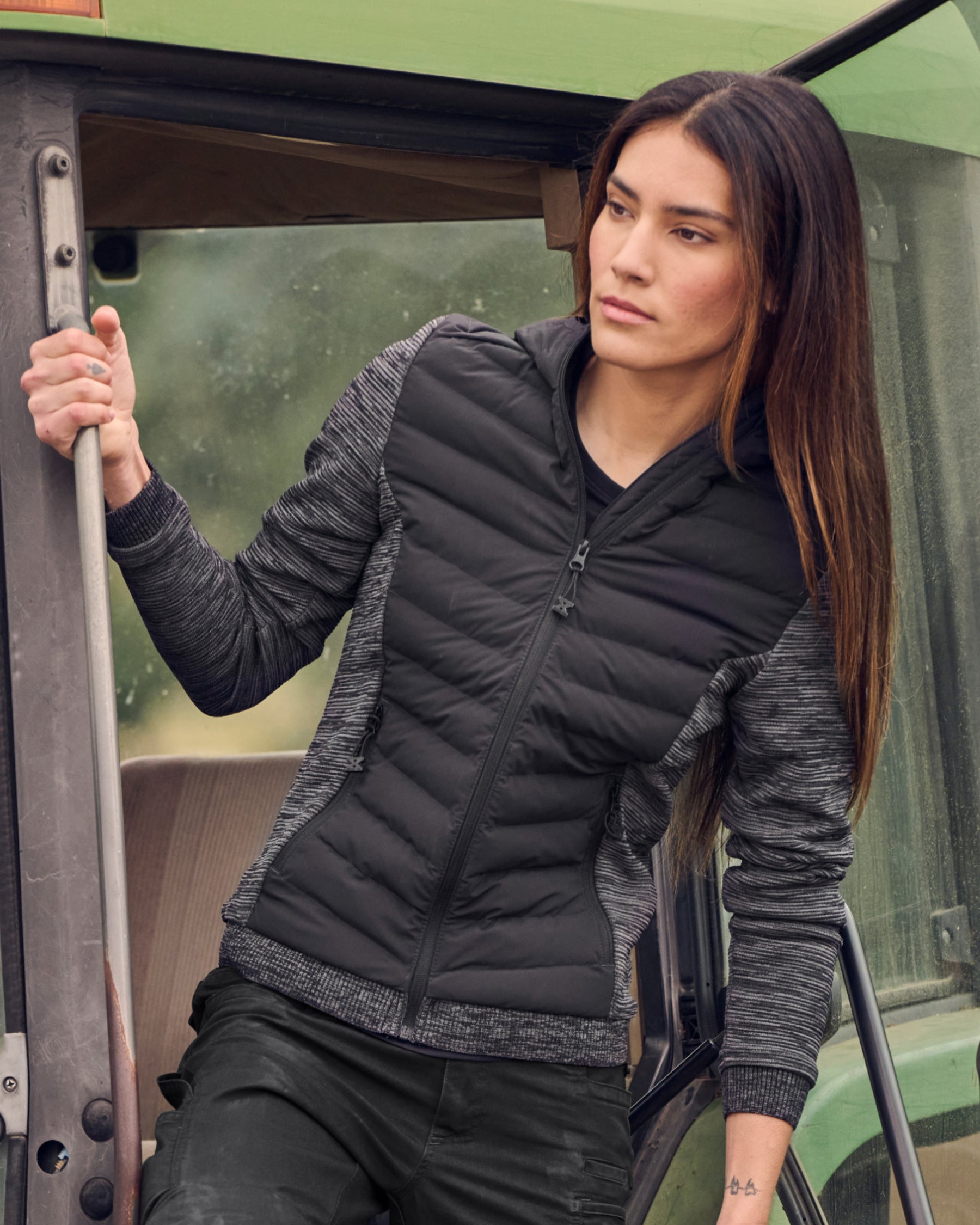STRAUSS women's e.s.motion ten hybrid hooded jacket in oxid black melange worn in a work setting