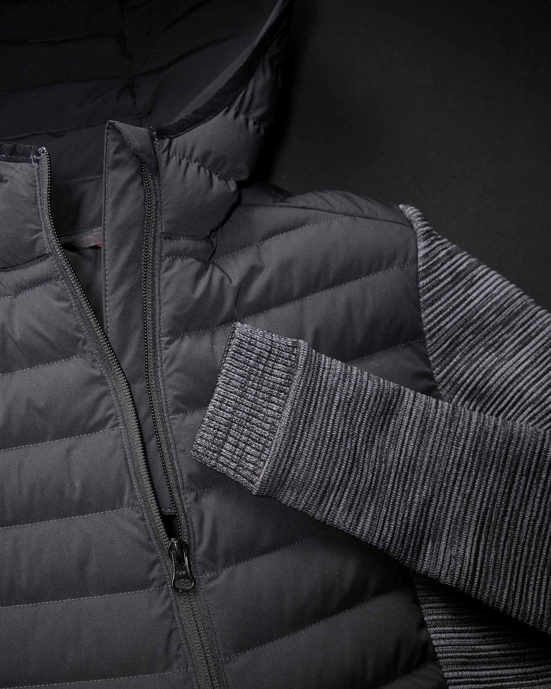 Close-up of quilted and stretch panel details on STRAUSS women's e.s.motion ten hybrid hooded jacket in oxid black melange