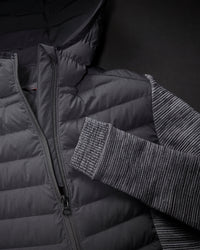 Close-up of quilted and stretch panel details on STRAUSS women's e.s.motion ten hybrid hooded jacket in oxid black melange