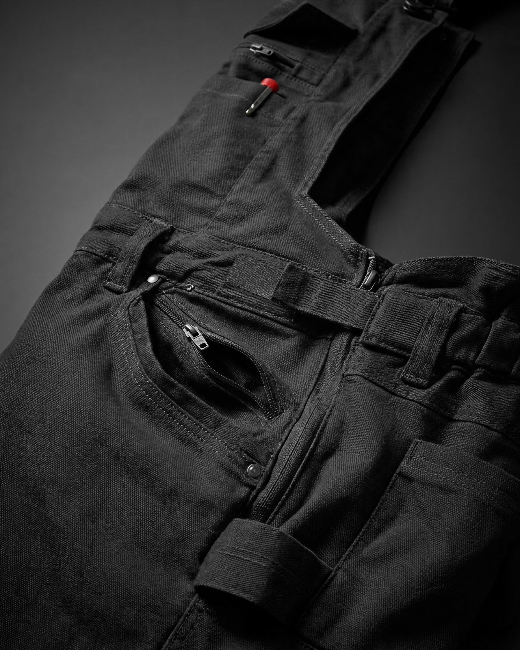 Close-up of black STRAUSS Multipocket Work Bib Overall e.s.vintage pocket and fabric details