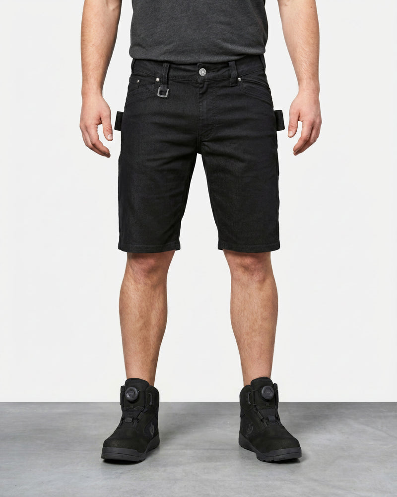 Model wearing Engelbert Strauss e.s. vintage multipocket shorts in black, showing the fit, length, waistband, and front pocket layout of the rugged multipocket work shorts with a vintage workwear look.