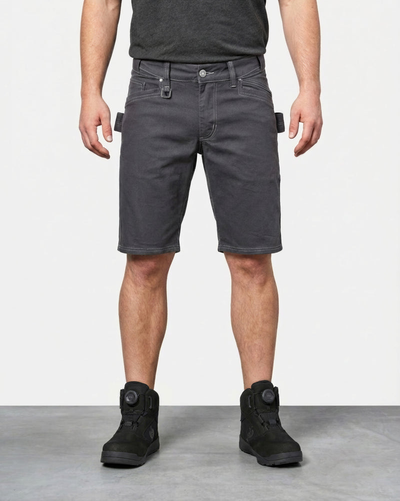 Model wearing Engelbert Strauss e.s. vintage multipocket shorts in pewter, showing the fit, length, waistband, and front pocket layout of the rugged multipocket work shorts with a vintage workwear look.