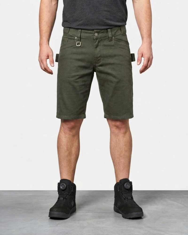 Model wearing Engelbert Strauss e.s. vintage multipocket shorts in disguise green, showing the fit, length, waistband, and front pocket layout of the rugged multipocket work shorts with a vintage workwear look.