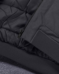 Close-up of pocket and hem details on STRAUSS e.s.iconic bomber jacket in black