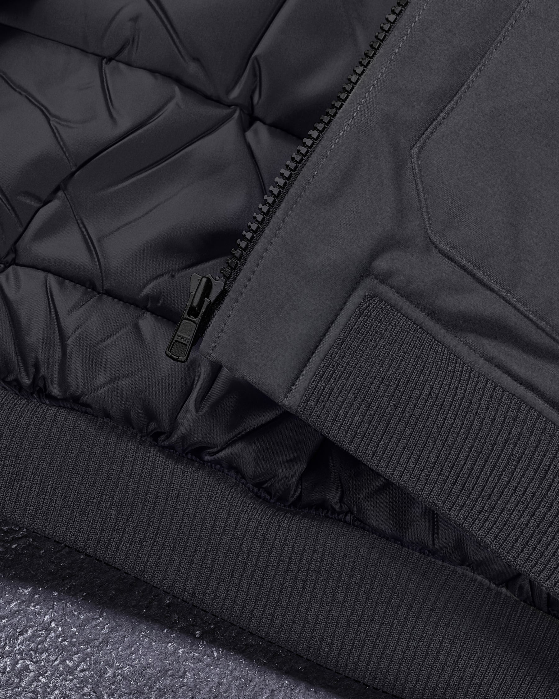Close-up of pocket and hem details on STRAUSS e.s.iconic bomber jacket in black