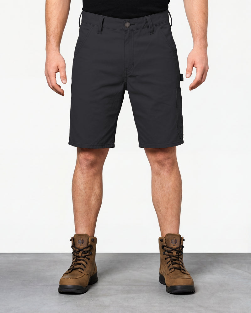 Model wearing Engelbert Strauss e.s. iconic shorts in black, showing the fit, length, waistband, and front pocket layout of the classic work shorts with functional pocket details.