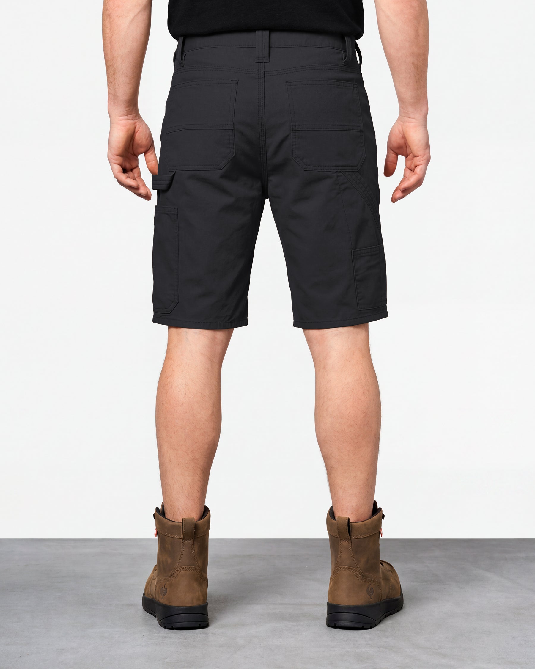 Alternate model view of Engelbert Strauss e.s. iconic shorts in black, showing the side and back fit with visible utility pocket placement and workwear construction.