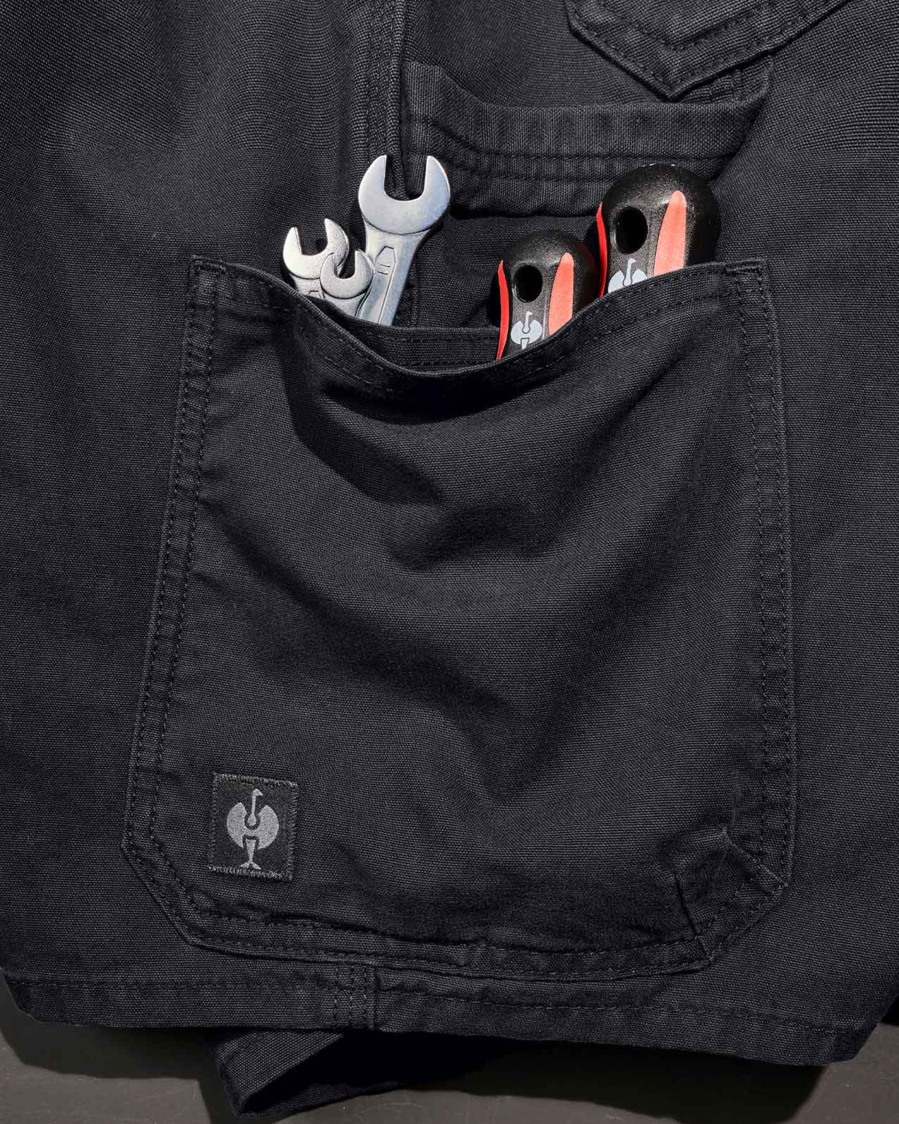 Additional close-up detail of Engelbert Strauss e.s. iconic shorts in black, showing fabric texture, stitching, and functional finishing details.