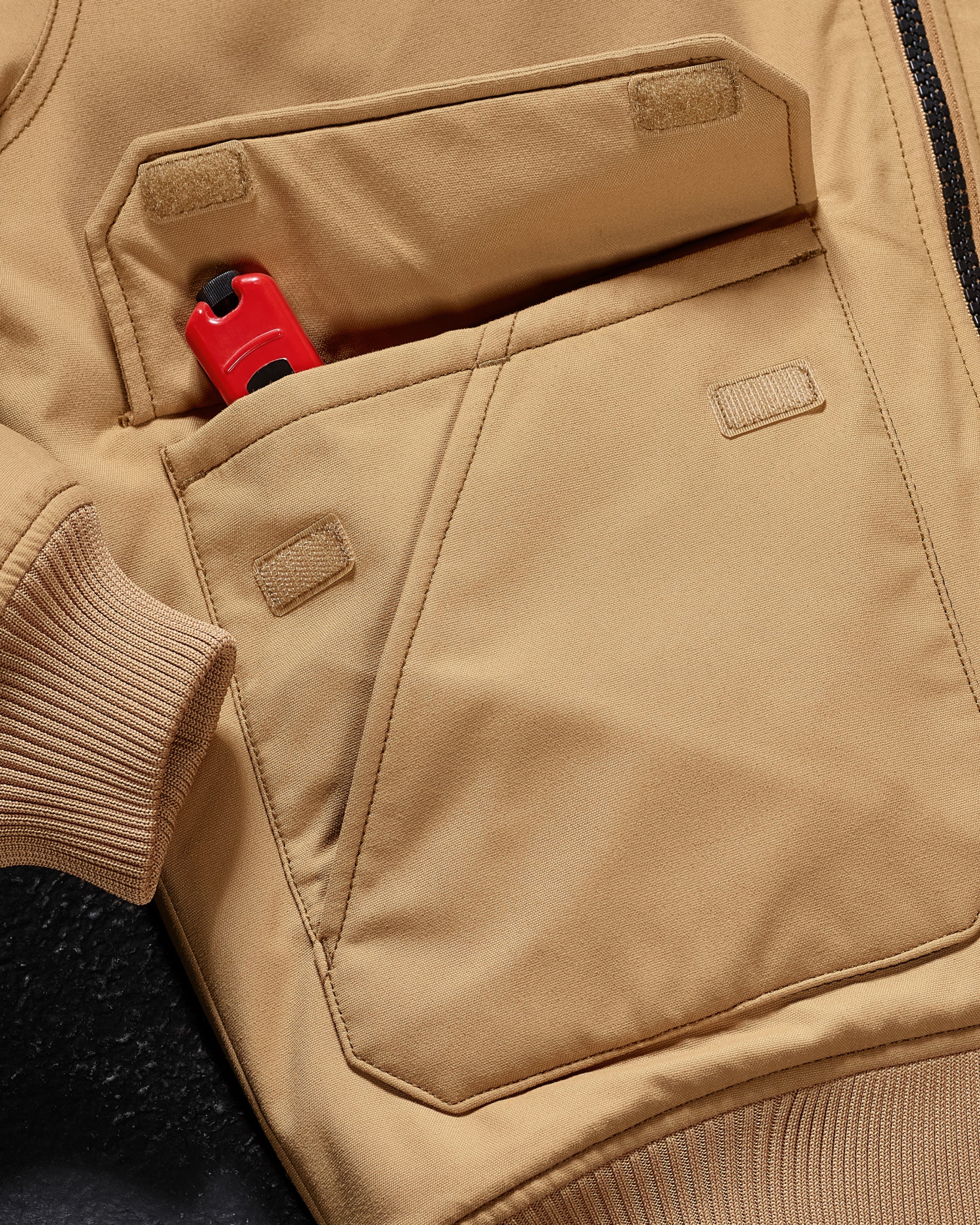 Close-up of ribbed collar and zipper details on STRAUSS e.s.iconic bomber jacket in almond brown