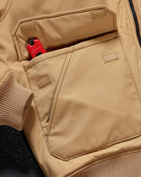 Close-up of ribbed collar and zipper details on STRAUSS e.s.iconic bomber jacket in almond brown