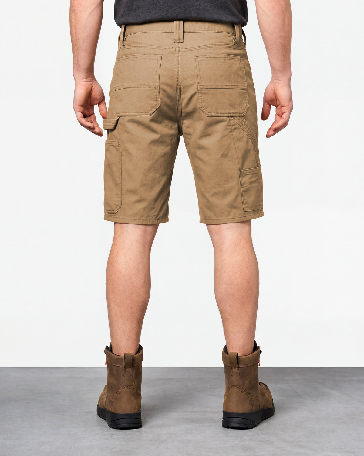 Alternate model view of Engelbert Strauss e.s. iconic shorts in almond brown, showing the side and back fit with visible utility pocket placement and workwear construction.