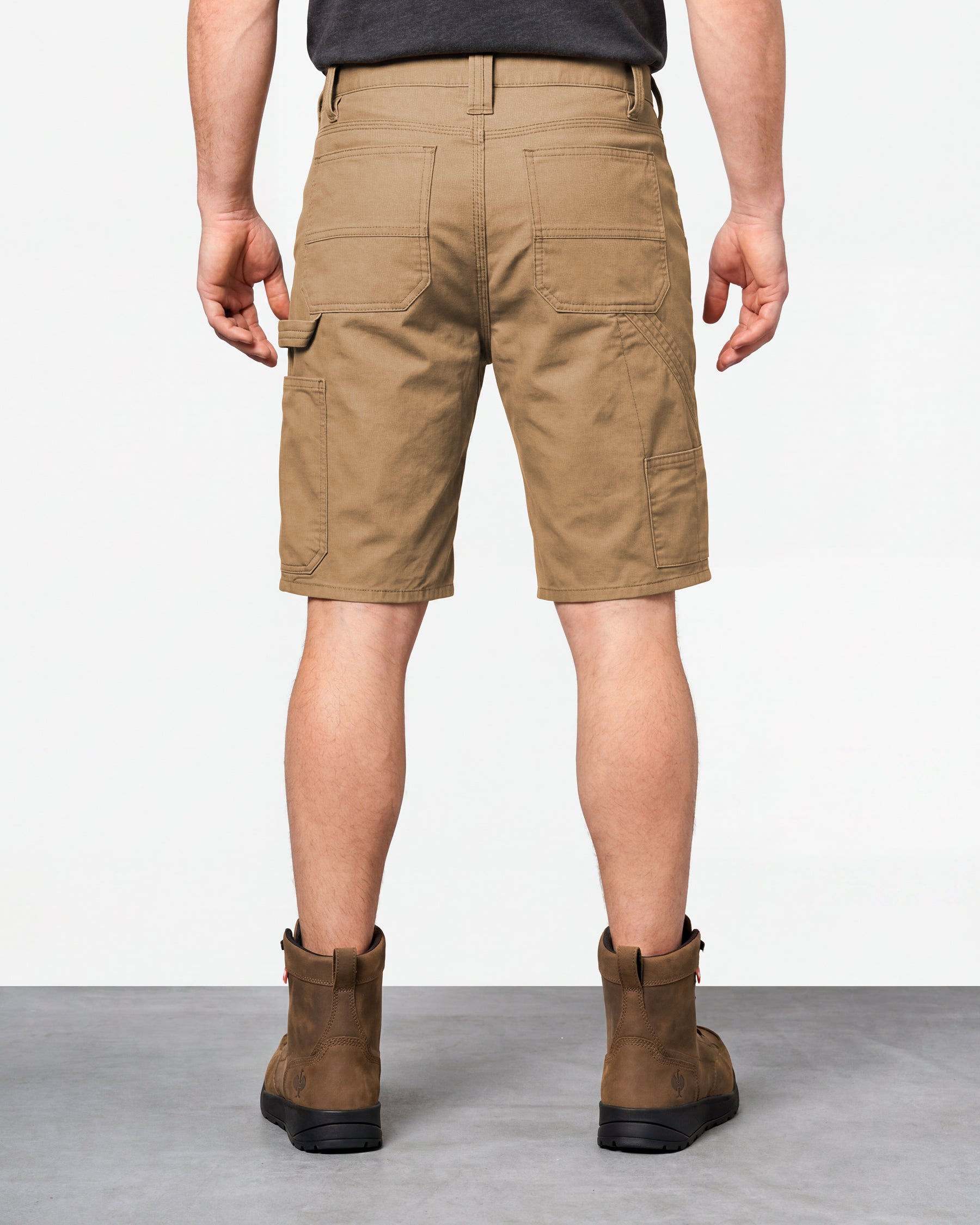 Alternate model view of Engelbert Strauss e.s. iconic shorts in almond brown, showing the side and back fit with visible utility pocket placement and workwear construction.