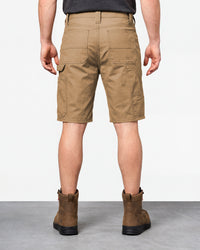 Alternate model view of Engelbert Strauss e.s. iconic shorts in almond brown, showing the side and back fit with visible utility pocket placement and workwear construction.