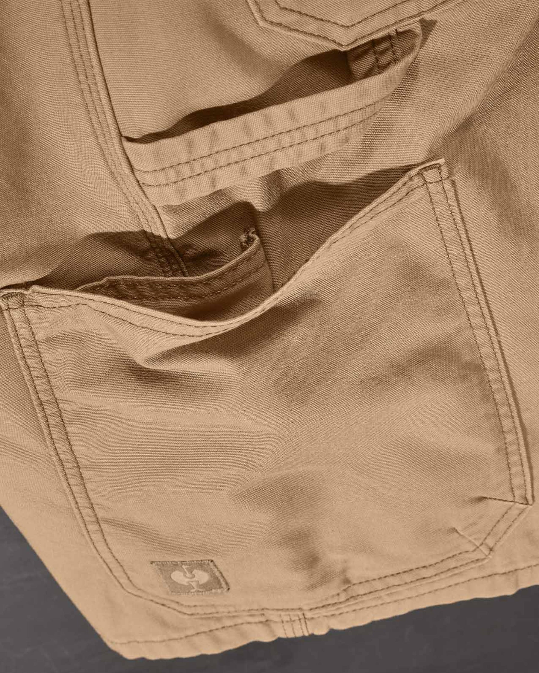 Additional close-up detail of Engelbert Strauss e.s. iconic shorts in almond brown, showing fabric texture, stitching, and functional finishing details.