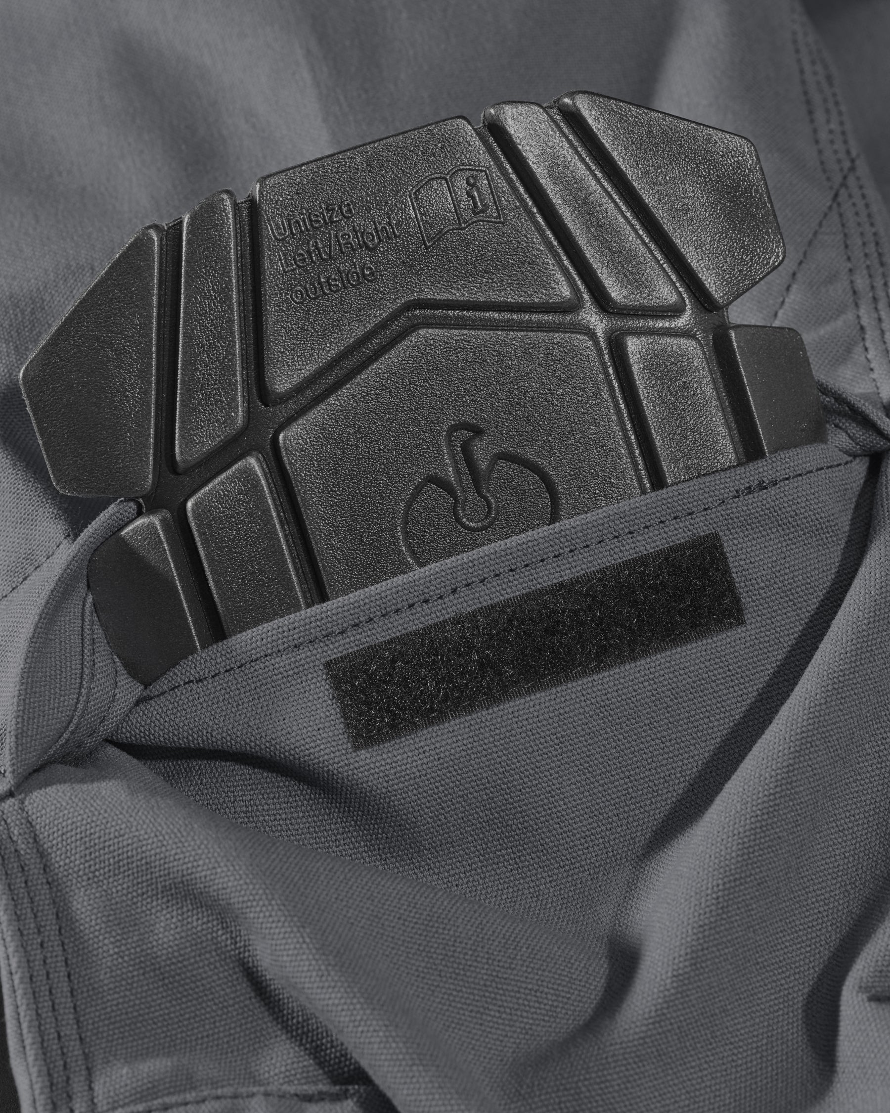 Close-up of knee pad pocket details on Pocket Protected Work Pants e.s.iconic in carbon gray