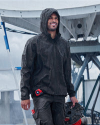 STRAUSS e.s.trail light pack windbreaker in black shown during outdoor work