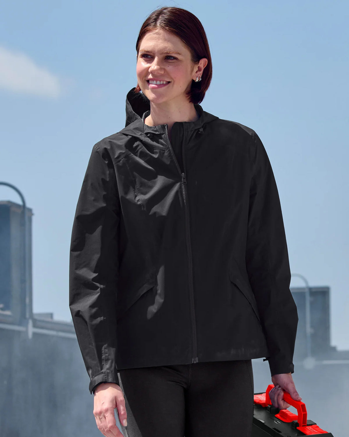 STRAUSS women's e.s.trail light pack windbreaker in black worn in a work setting