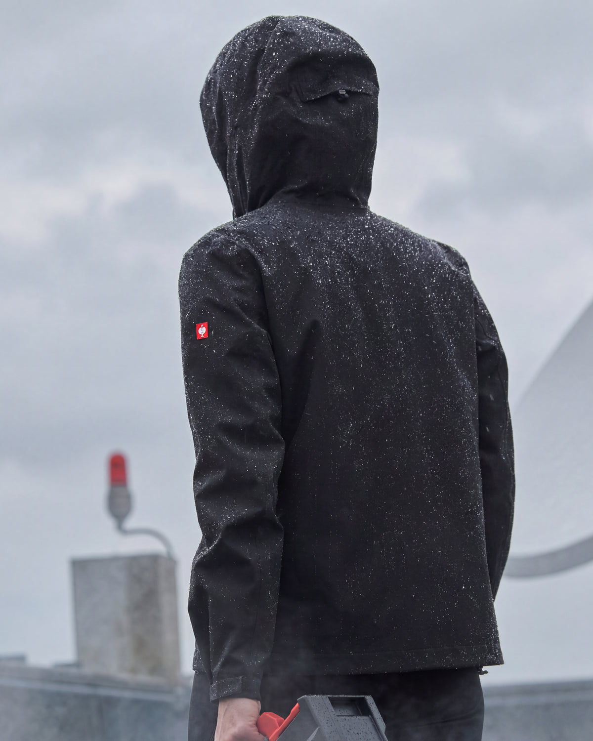 STRAUSS women's e.s.trail light pack windbreaker in black in use on the job