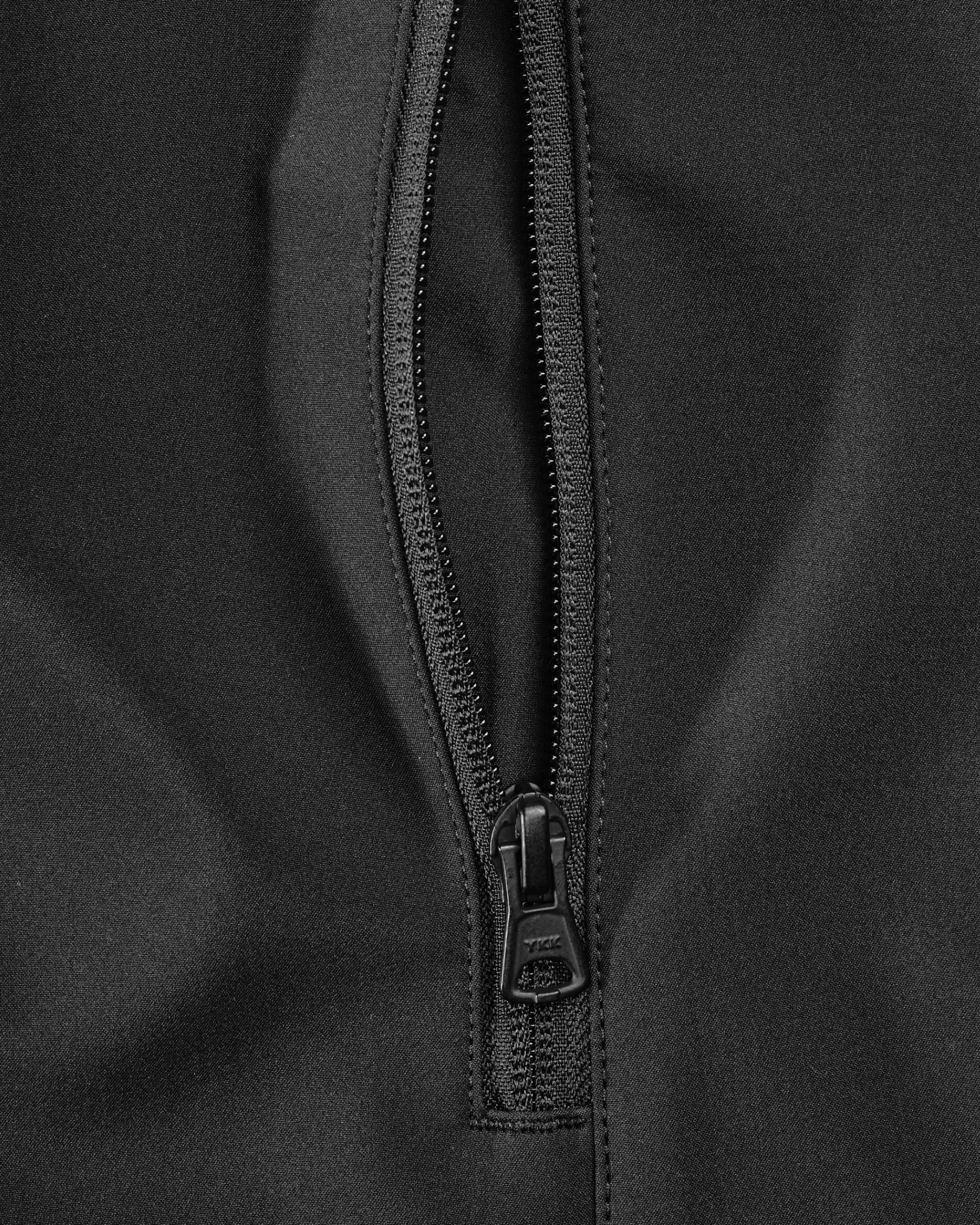 Close-up of pocket and hood details on STRAUSS e.s.trail pure softshell jacket in black and carbon gray
