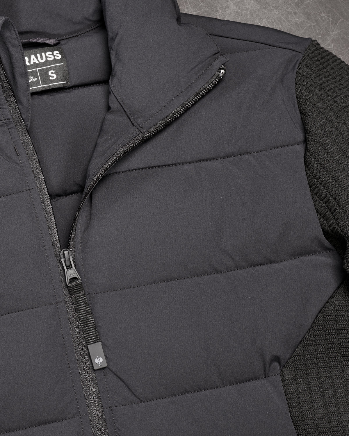 Close-up of quilted and stretch panel details on STRAUSS e.s.trail pure hybrid jacket in black